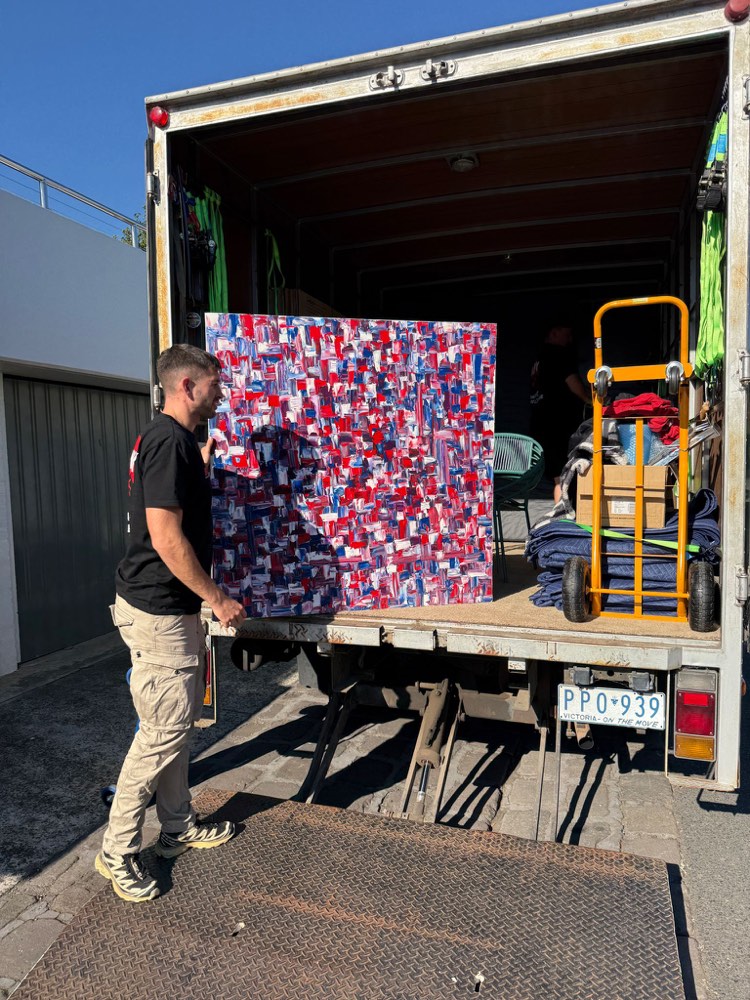 Ben loading one of Isabella’s paintings into the truck